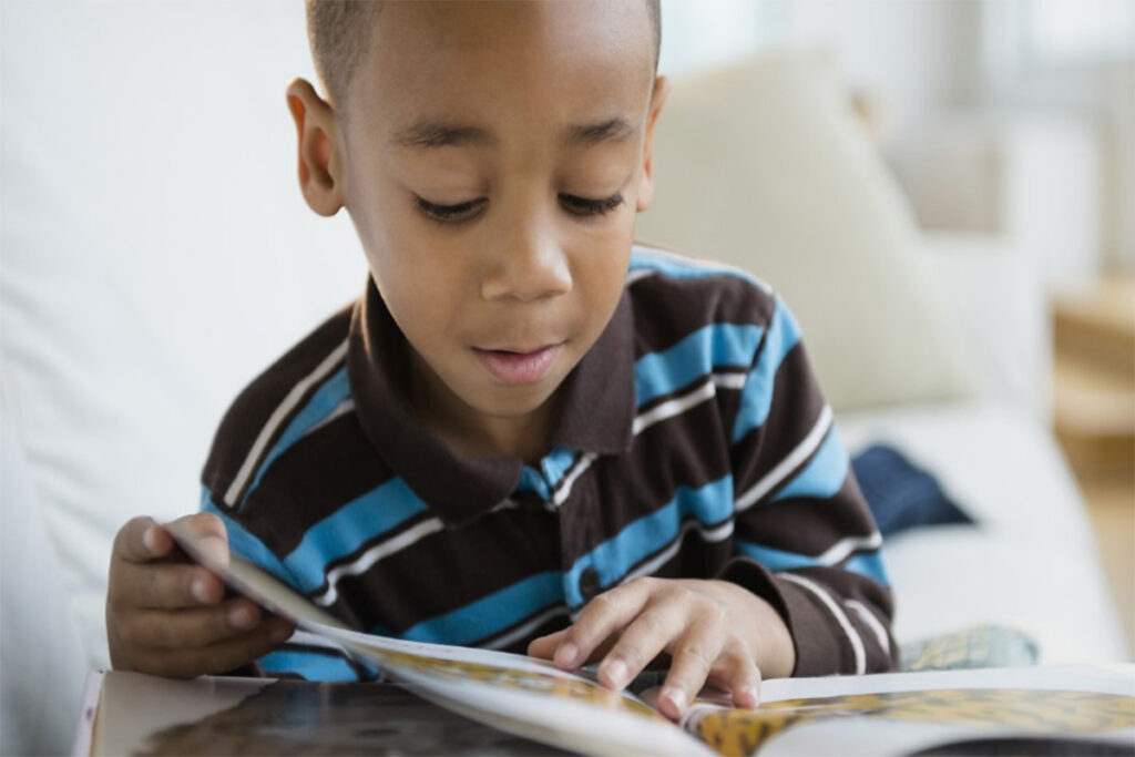 young boy reading