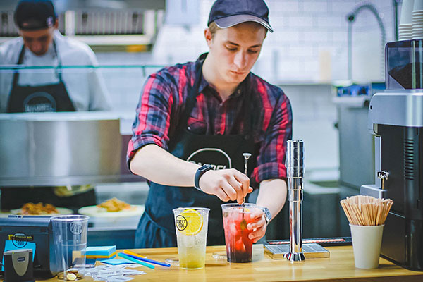 Disgruntled Employee Mixing Drinks